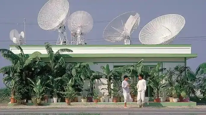 Three Surfers Waiting beside a Faded Roadside 4, a Midjourney sref remix: three surfers waiting beside a faded roadside fruit stand before dawn, sun-bleached glass satellites orbit backward through a silent film studio, surrounded by enormous houseplants, surreal photo style
