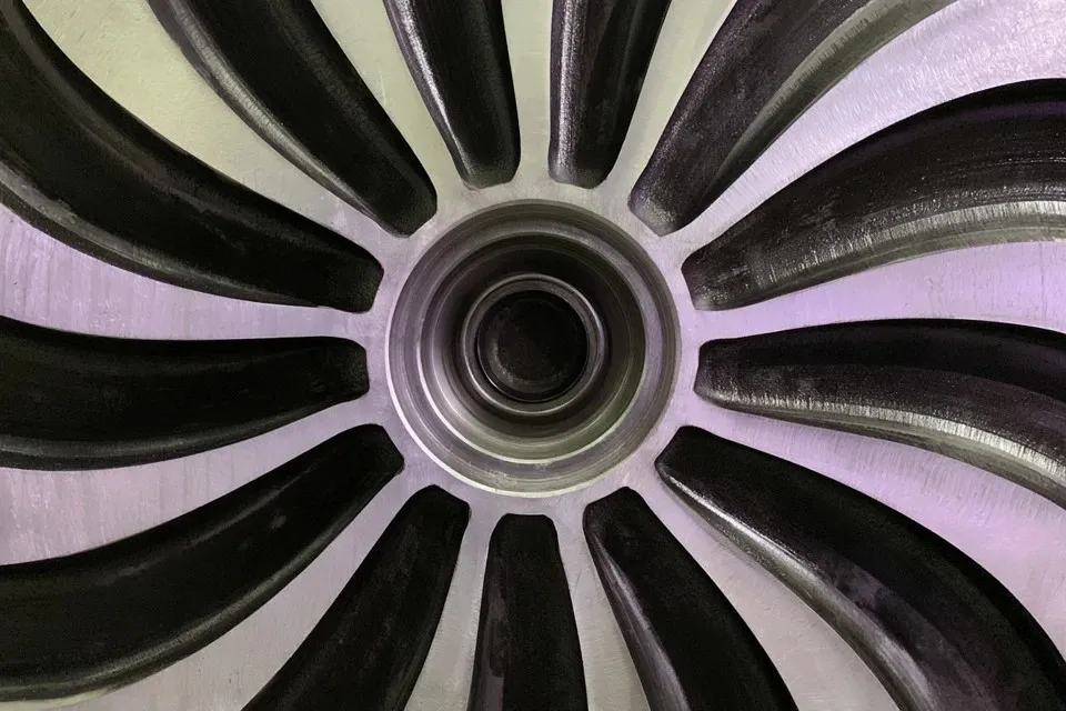 Hydroelectric Turbine Runner Wheel, a Midjourney sref remix: hydroelectric turbine runner wheel, curved stainless steel blades and central hub, machine-finished surfaces catching light, brutal photo style